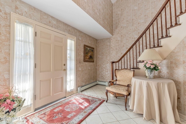 foyer featuring a baseboard heating unit and light tile patterned floors