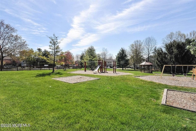 view of community with fence, a lawn, and playground community