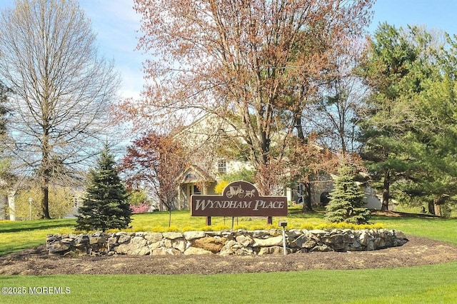 community / neighborhood sign with a yard