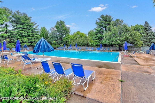 pool featuring a patio and fence