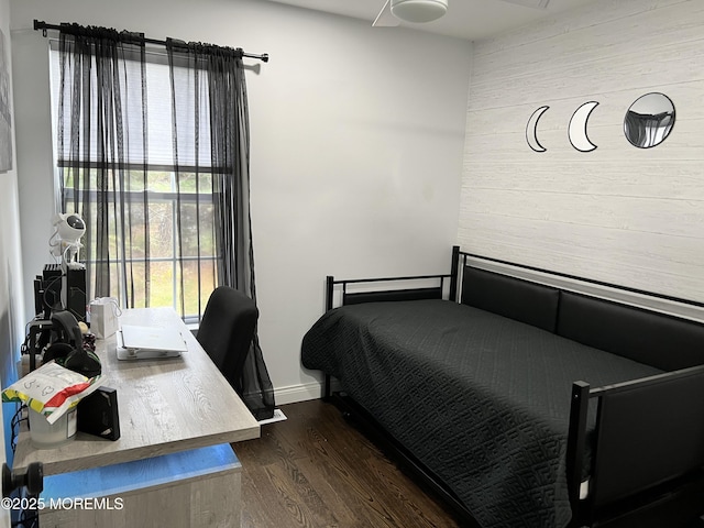 bedroom with dark wood-style floors and baseboards