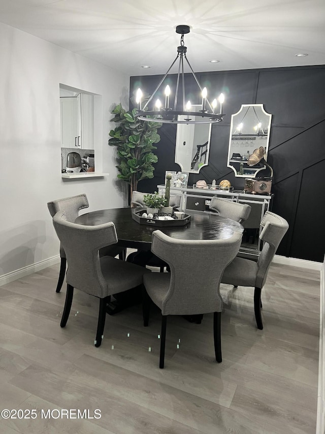 dining room with a notable chandelier and baseboards