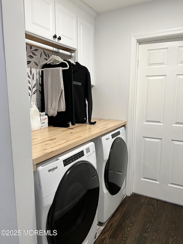 clothes washing area featuring cabinet space, separate washer and dryer, and dark wood finished floors