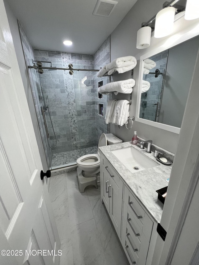 full bathroom featuring vanity, visible vents, a shower stall, toilet, and marble finish floor