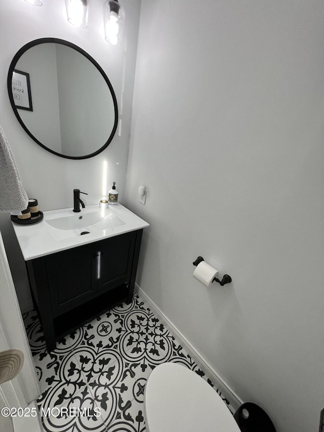 bathroom featuring tile patterned flooring, vanity, and baseboards