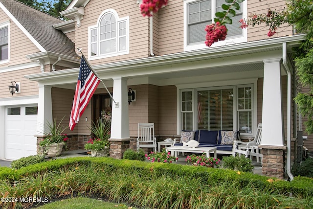 view of front of property featuring a garage, a porch, and a shingled roof