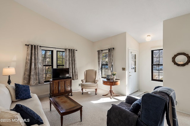 carpeted living room featuring lofted ceiling and a wealth of natural light