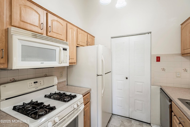 kitchen featuring tasteful backsplash, light brown cabinetry, and white appliances