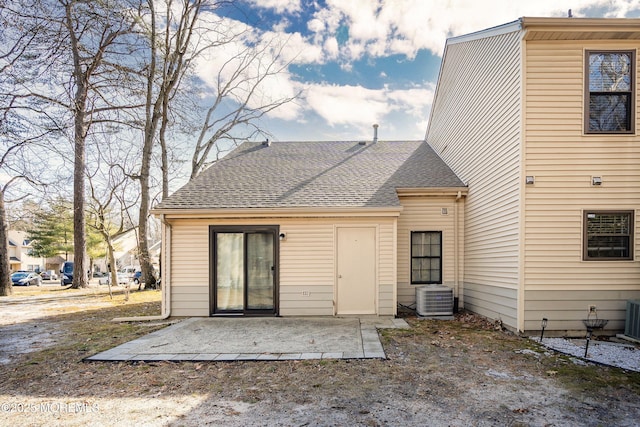 rear view of property with a patio area and central air condition unit