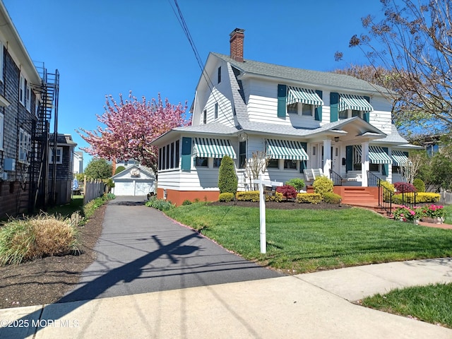 630 Main Ave, Bay Head, NJ 08742 - view of front of house with a chimney, an outbuilding, a front lawn, a gambrel roof, and a shingled roof