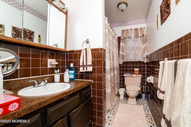 bathroom featuring toilet, tile walls, vanity, a shower with shower curtain, and tile patterned flooring