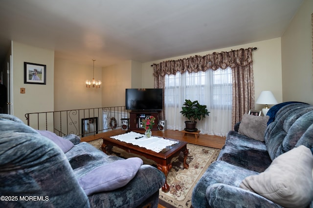 living room with hardwood / wood-style floors and a chandelier