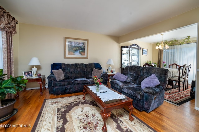 living room with wood-type flooring and a notable chandelier