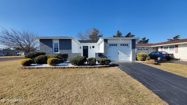 single story home with a garage and a front lawn