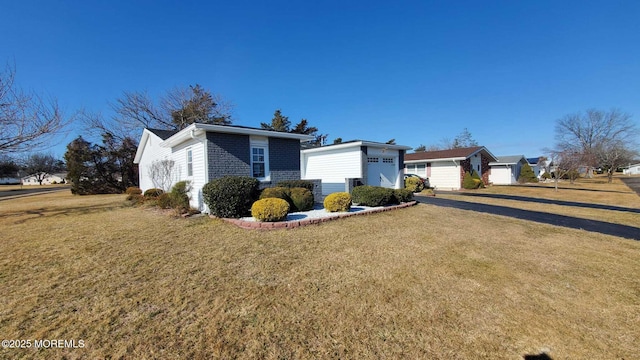 view of front of home with a garage and a front yard