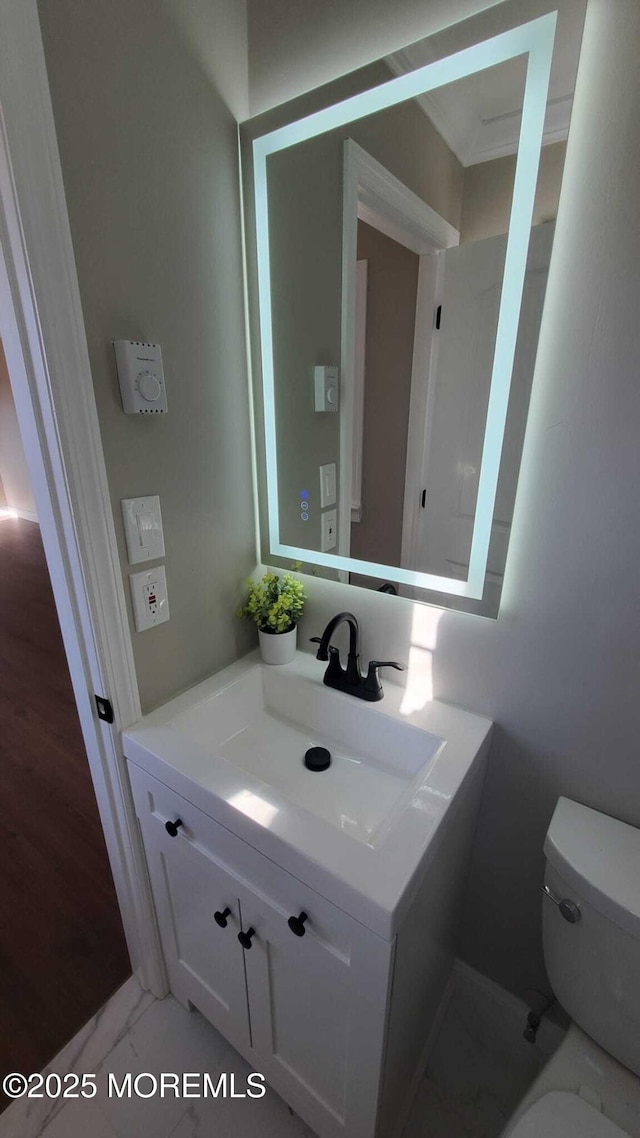 bathroom featuring vanity and toilet