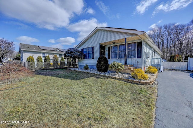 view of front of property with a front lawn and fence