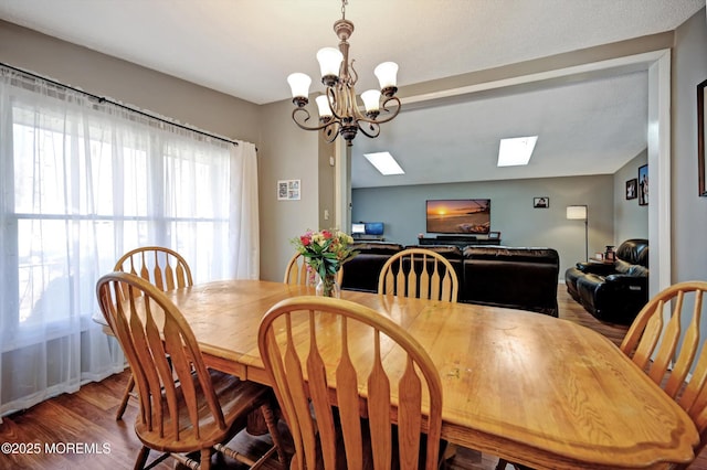 dining area featuring a notable chandelier and wood finished floors