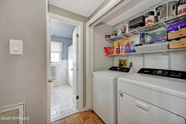 clothes washing area featuring laundry area and separate washer and dryer