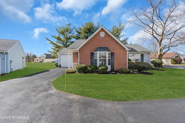 view of front of home featuring a garage, brick siding, a front yard, and aphalt driveway