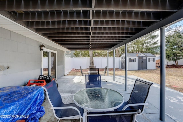 view of patio with a storage shed