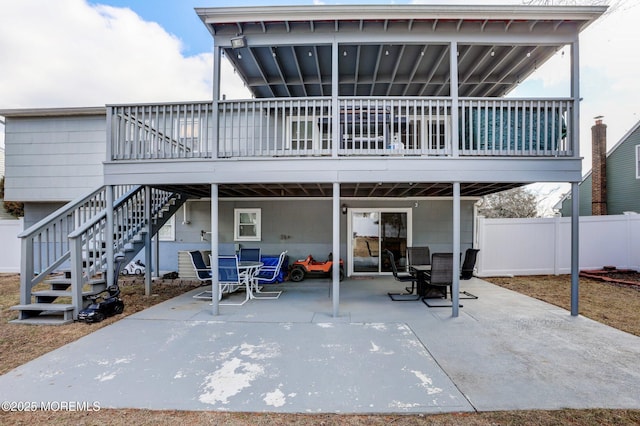 back of property with a deck and a patio area