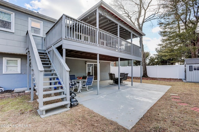 back of house with a deck and a patio area