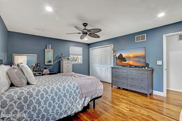 bedroom with a closet, ceiling fan, and light wood-type flooring