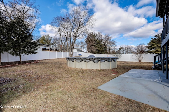 view of yard featuring a patio and a covered pool