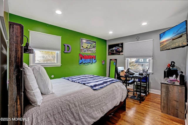 bedroom featuring multiple windows and light hardwood / wood-style floors