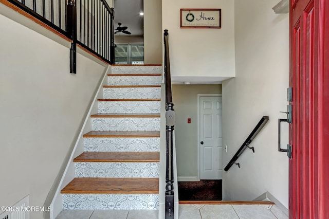 stairway featuring tile patterned flooring