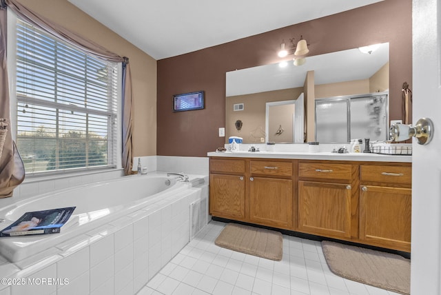 bathroom featuring tile patterned floors, double vanity, a shower stall, and a bath