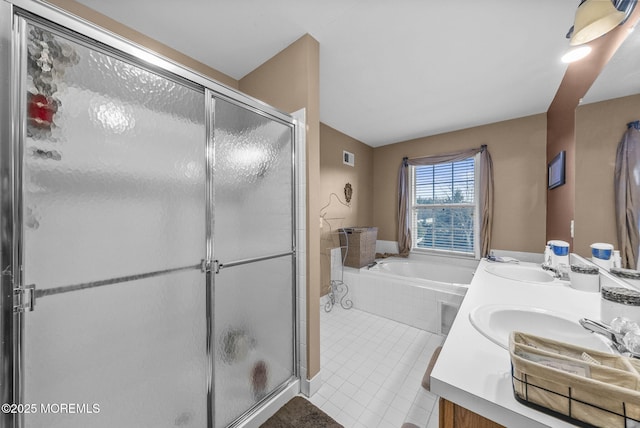 full bath featuring a sink, a stall shower, a garden tub, and tile patterned floors