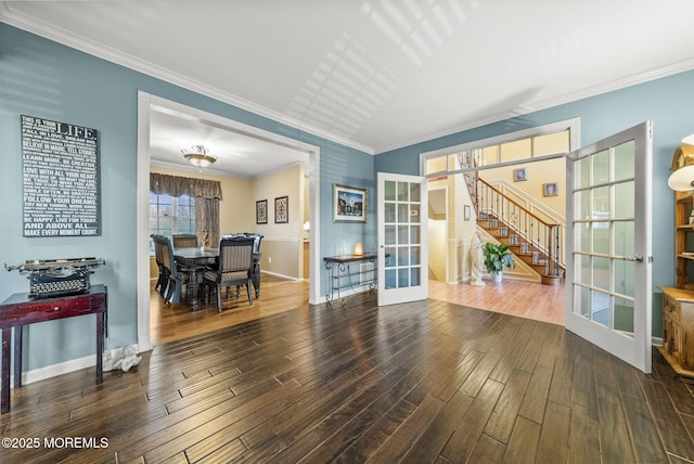 interior space with wood finished floors, baseboards, stairs, french doors, and ornamental molding