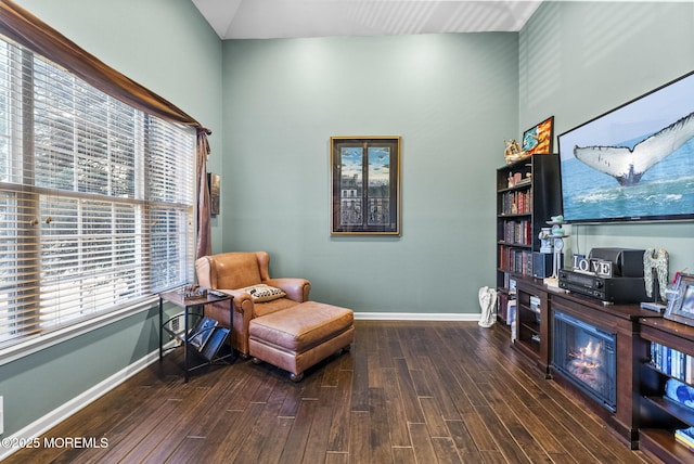 living area featuring baseboards and wood finished floors