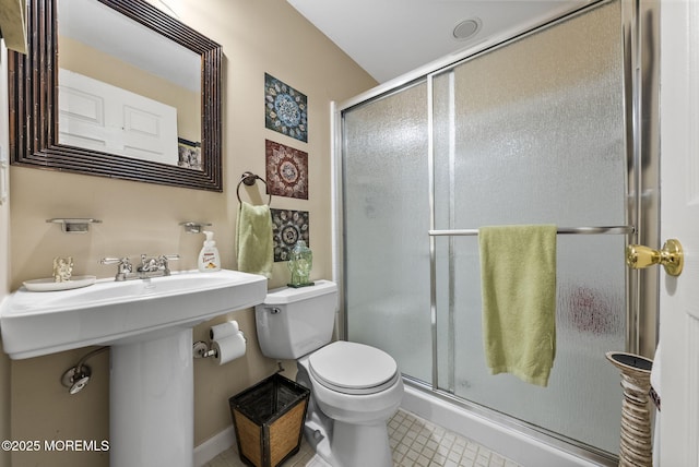 bathroom with a stall shower and toilet