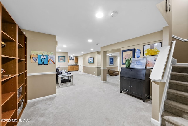 sitting room featuring recessed lighting, light colored carpet, visible vents, baseboards, and stairs