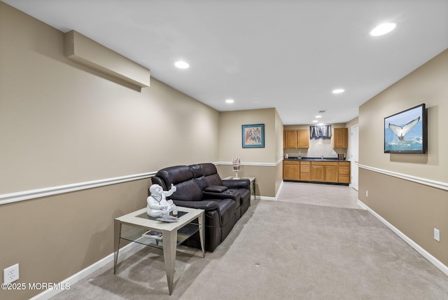 living area featuring light carpet, baseboards, and recessed lighting