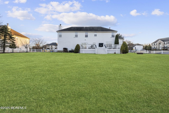 back of house featuring a fenced backyard and a yard