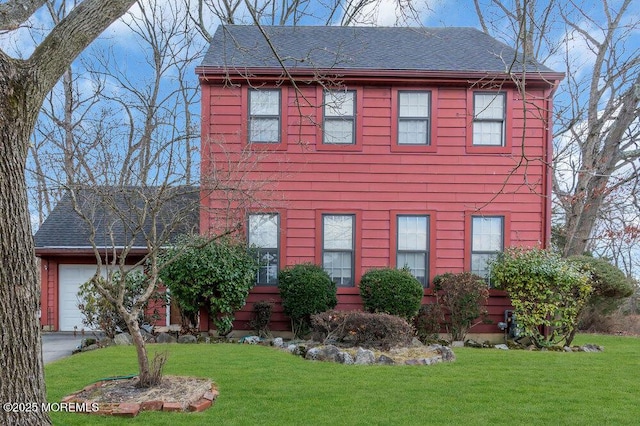 view of front of property featuring a garage and a front lawn