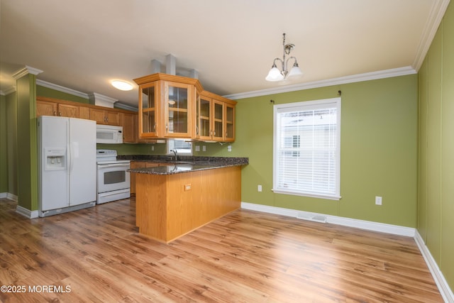 kitchen with white appliances, ornamental molding, kitchen peninsula, and sink