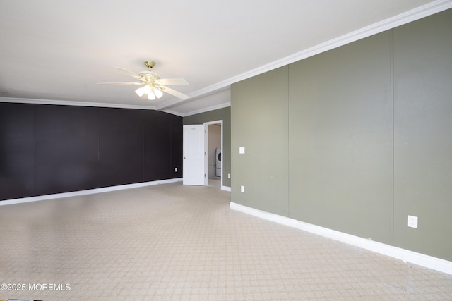 spare room featuring crown molding, washer / dryer, and ceiling fan