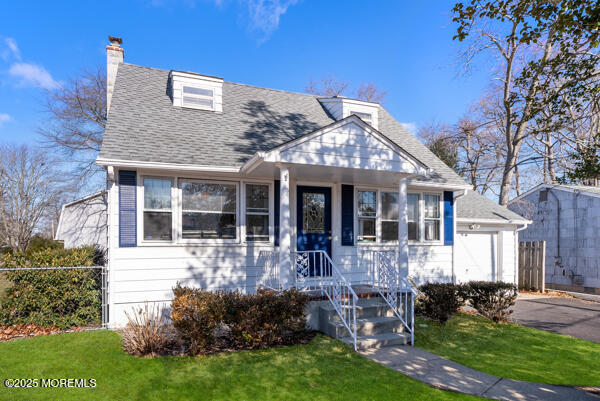 view of front of home with a front lawn and a garage