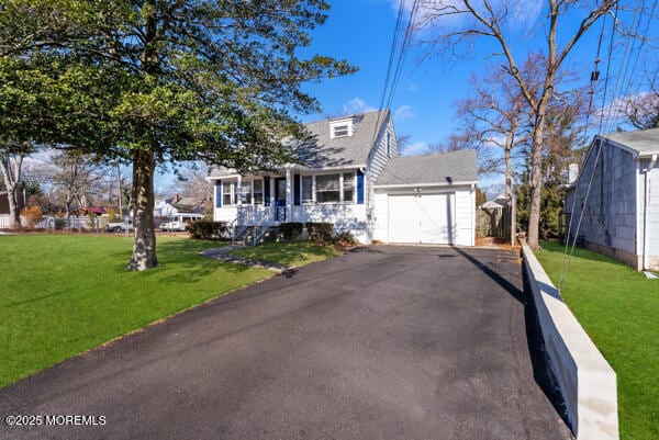 cape cod house with a front yard, a garage, and a porch