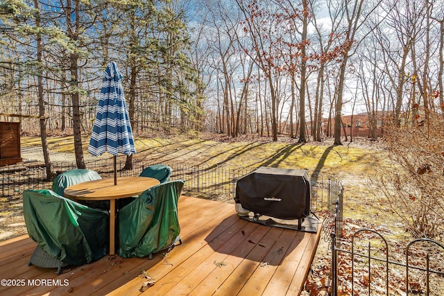 wooden terrace with a grill