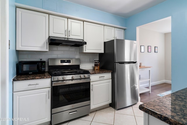 kitchen with stainless steel appliances, backsplash, white cabinets, and under cabinet range hood