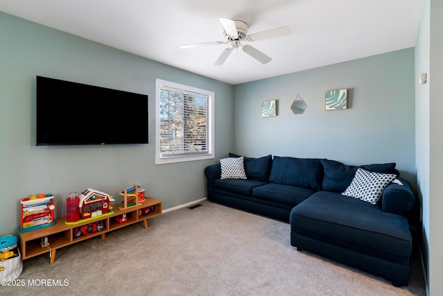 living area with a ceiling fan, light carpet, visible vents, and baseboards