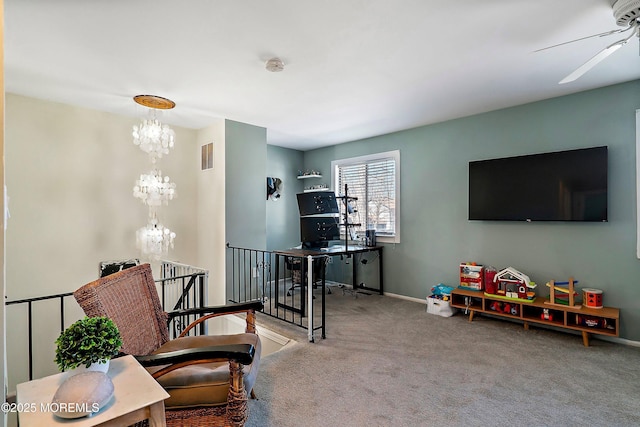 living room featuring visible vents, baseboards, carpet flooring, and ceiling fan with notable chandelier