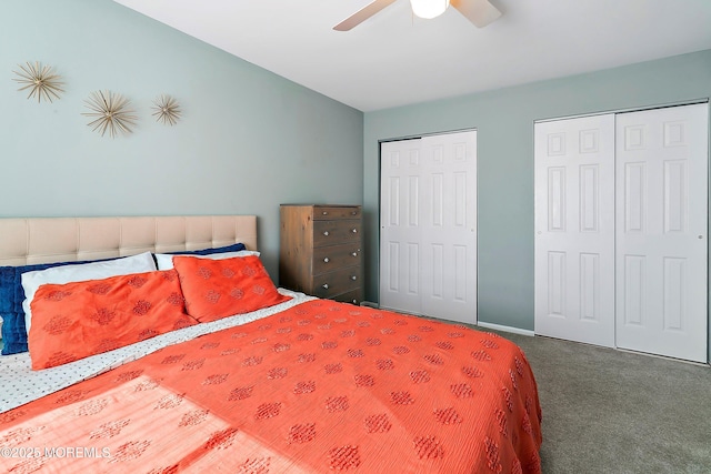 bedroom featuring carpet floors, ceiling fan, baseboards, and multiple closets