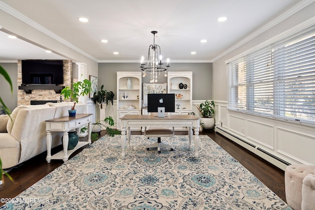 home office with dark wood-type flooring, ornate columns, a chandelier, baseboard heating, and ornamental molding